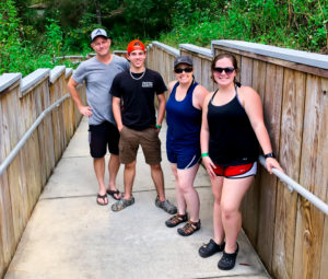 Anchored Scuba family standing together on the walkway to Troy Springs