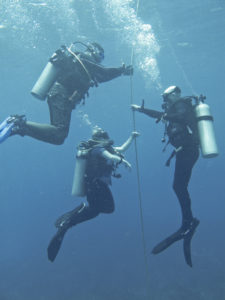 Divers hanging at a safety stop